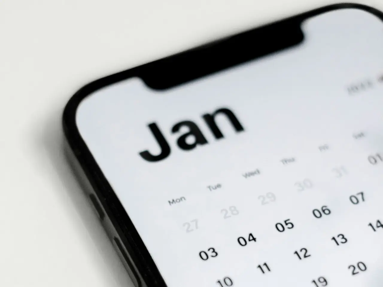 a close up of a cell phone with a calendar on it